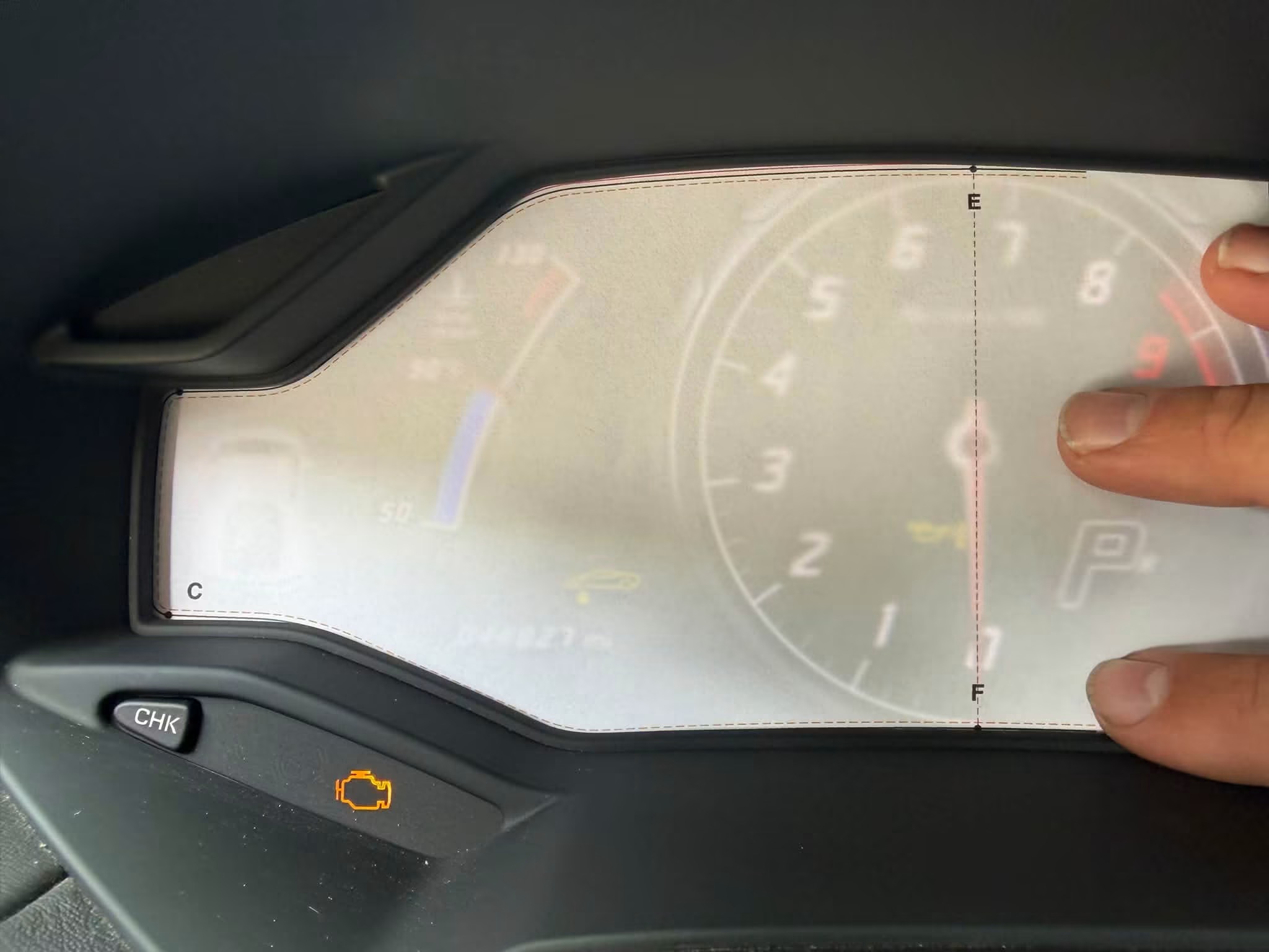 A paper pattern being checked against the actual Huracán screen edges